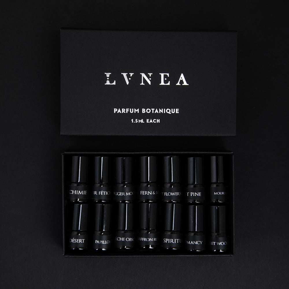 
                      
                        The full LVNEA parfum botanique sample set, presented in a black cardboard box. The lid is open, revealing all 14 sample vials of perfume neatly nestled together.
                      
                    