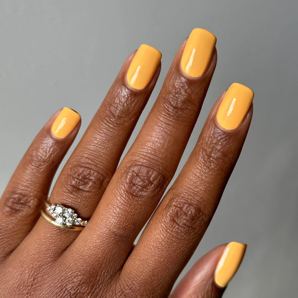 
                      
                        "Daffodil" nail polish shown on model's hand.
                      
                    