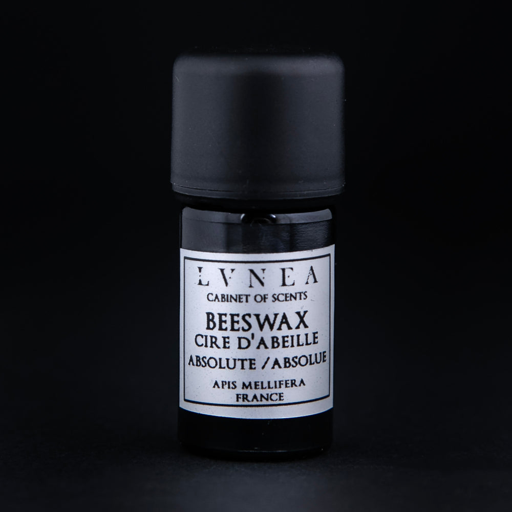 5ml black glass bottle of beeswax absolute on black background