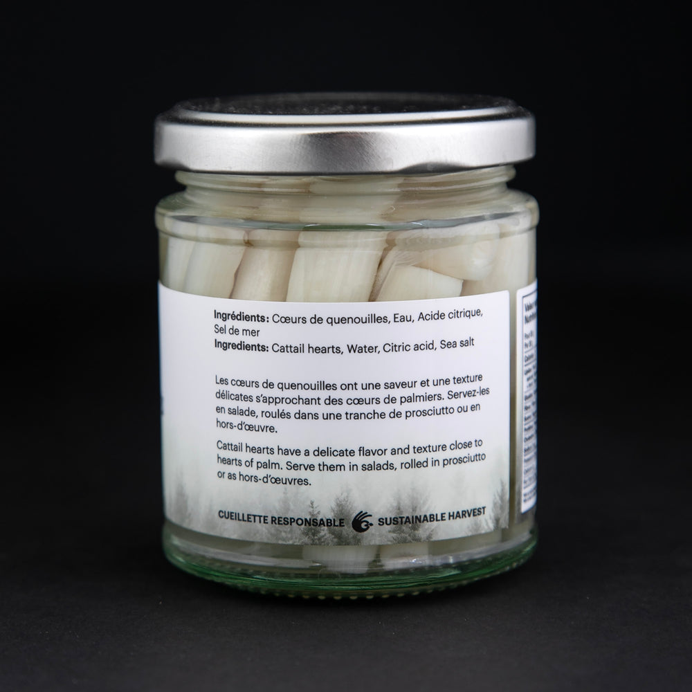 
                      
                        back label of cat tail hearts in a clear glass jar against a black background
                      
                    