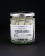 back label of cat tail hearts in a clear glass jar against a black background