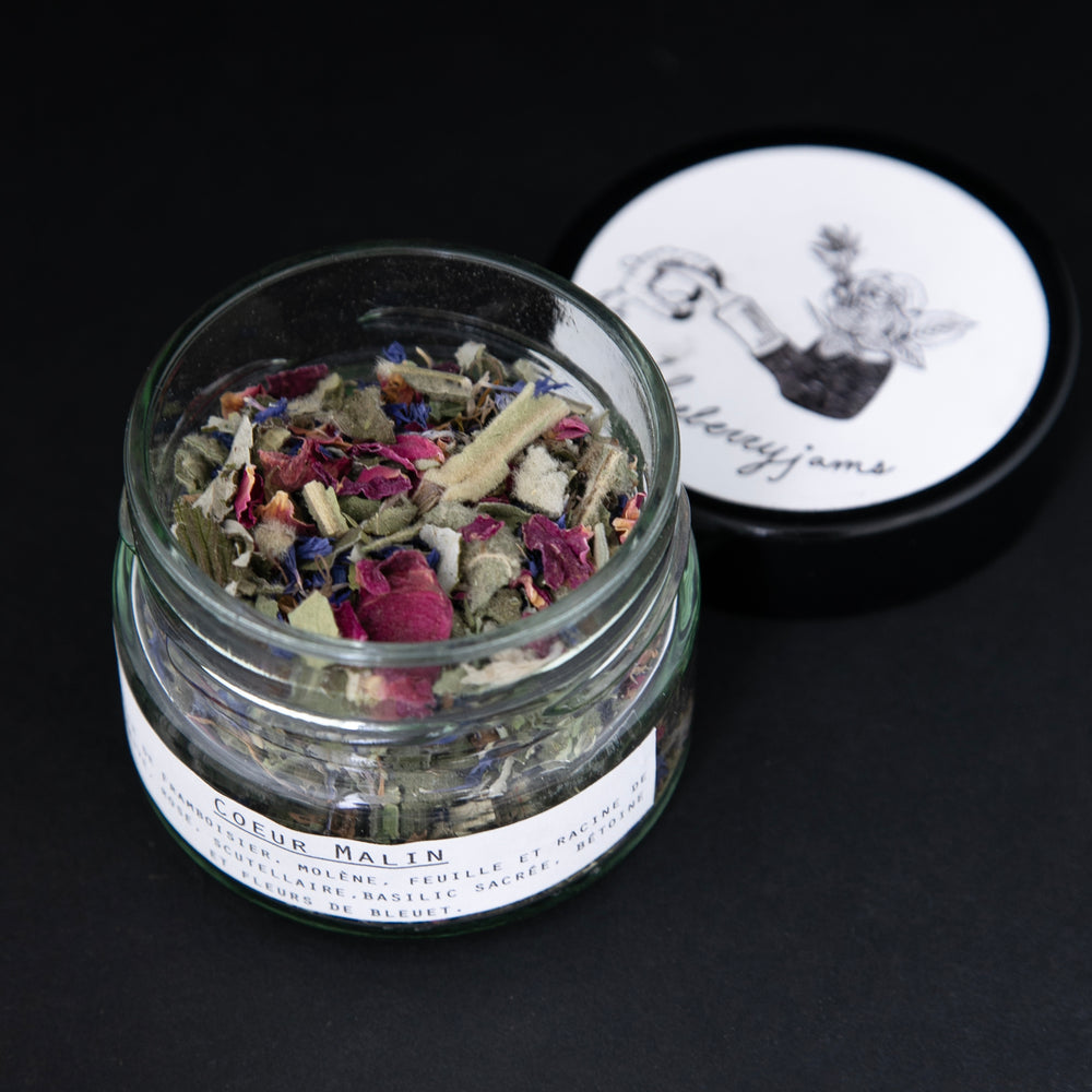 
                      
                        Open jar of Blueberryjams "Wicked Hearts" rolling blend, revealing a ciolourful herbal blend.
                      
                    