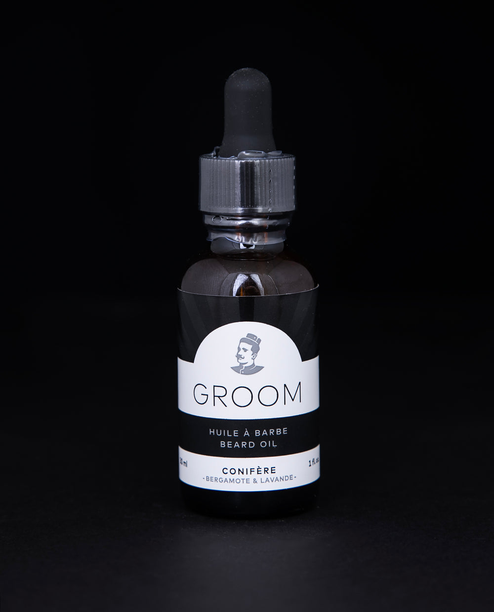 30ml amber glass bottle of Conifère beard oil against a black background