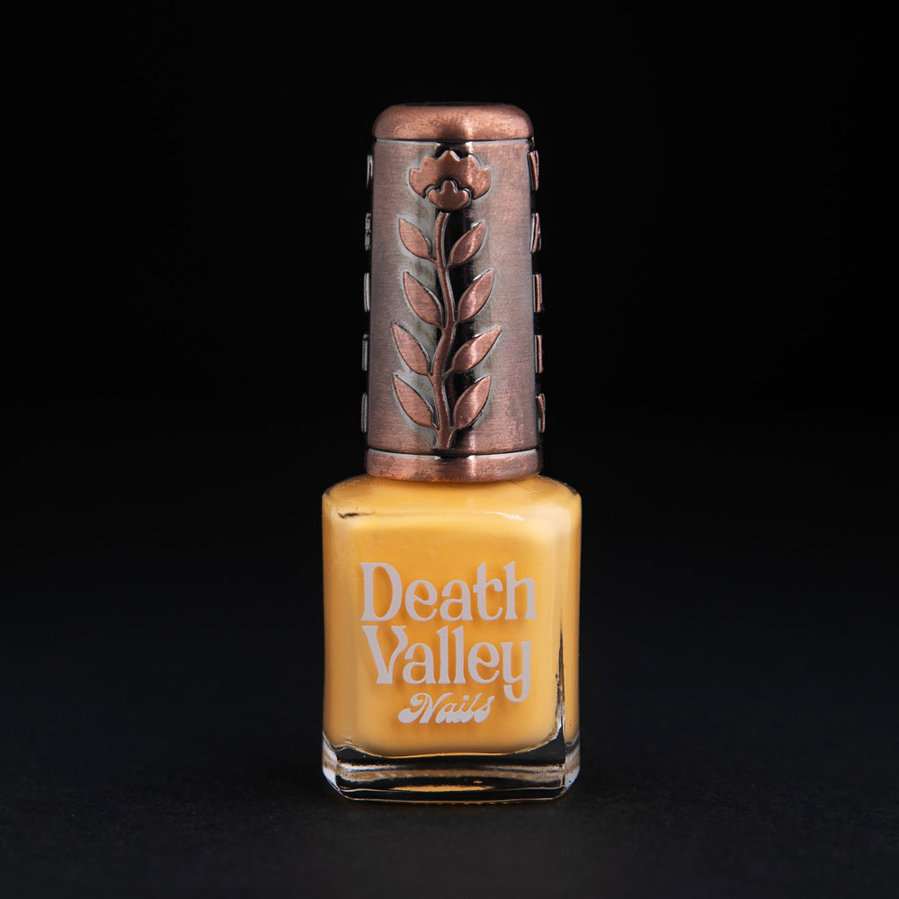 
                      
                        Bottle of "daffodil" nail polish on black background. The polish colour is a daffodil yellow.
                      
                    