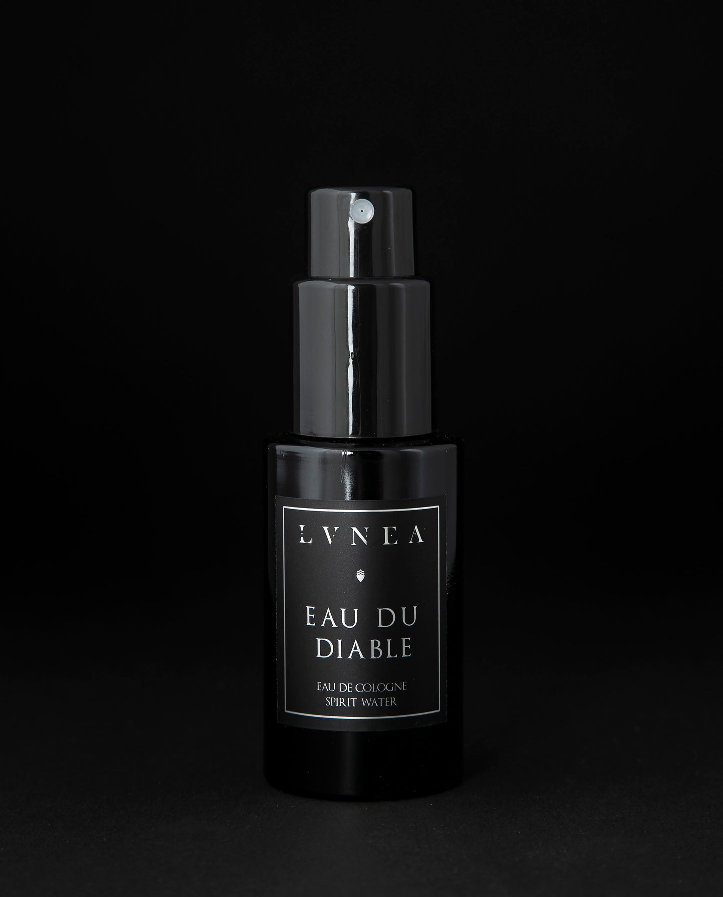 50ml black glass bottle of LVNEA’s Eau du Diable natural fragrance on black background