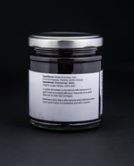 back label of a jar of elderberry jelly against a black background