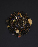 small pile of "flower moon" tea viewed from above against a black background