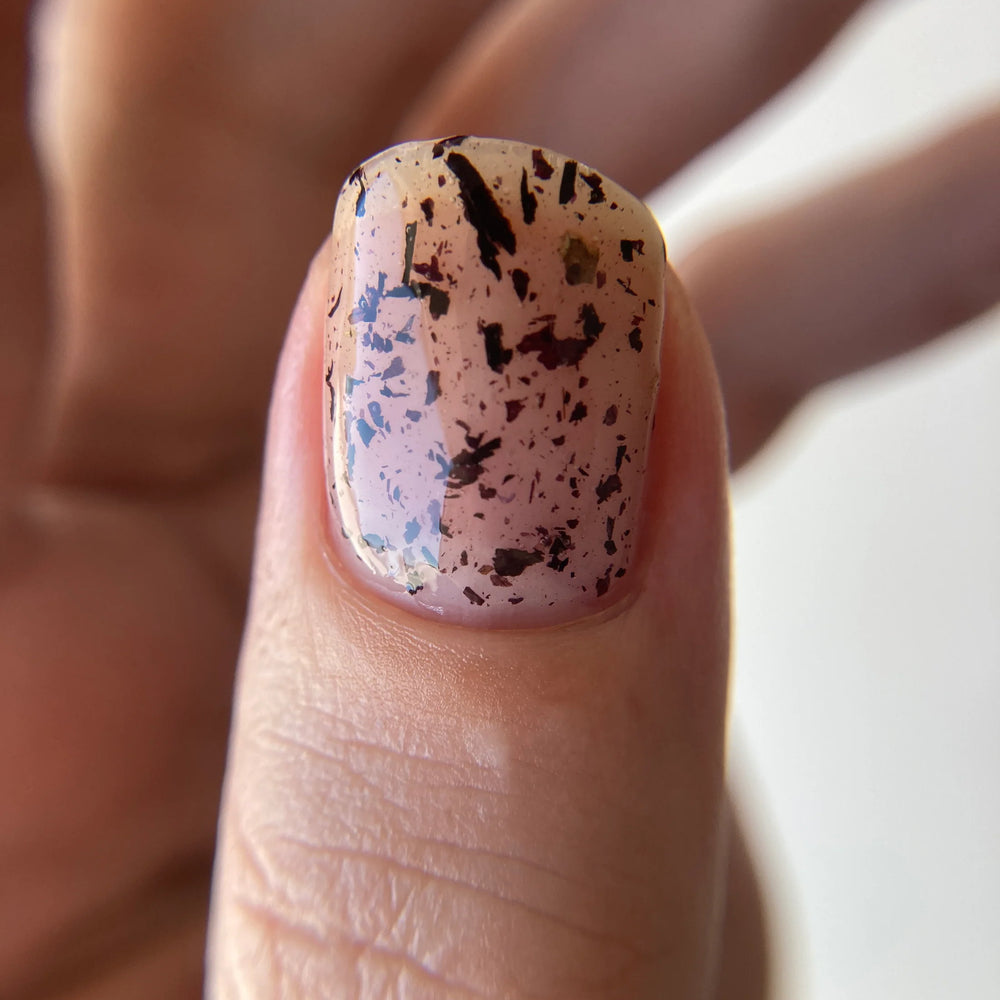 
                      
                        Close up of thumb nailpainted with Death Valley Nails' "hollyhock" nail polish
                      
                    