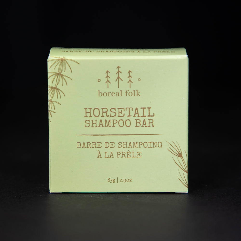 light green cardboard box of Boreal Folk's horsetail shampoo against a black background