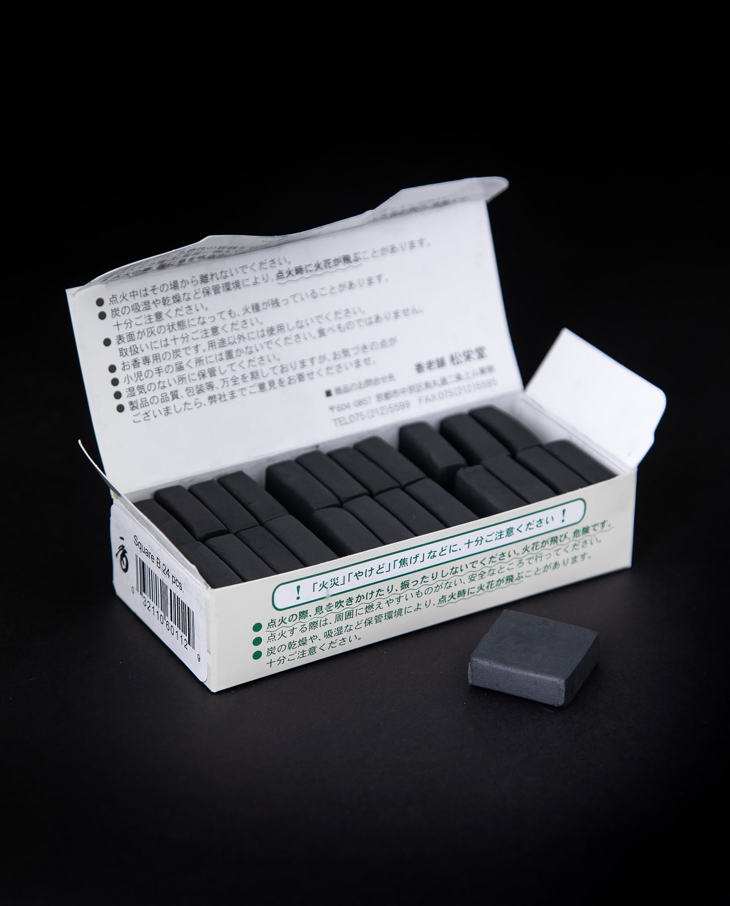 open box of Japanese incense charcoal against a black background