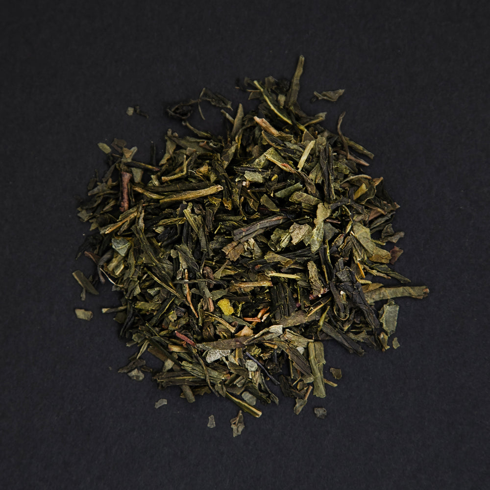 
                      
                        small pile of "iskandar" tea viewed from above against a black background
                      
                    