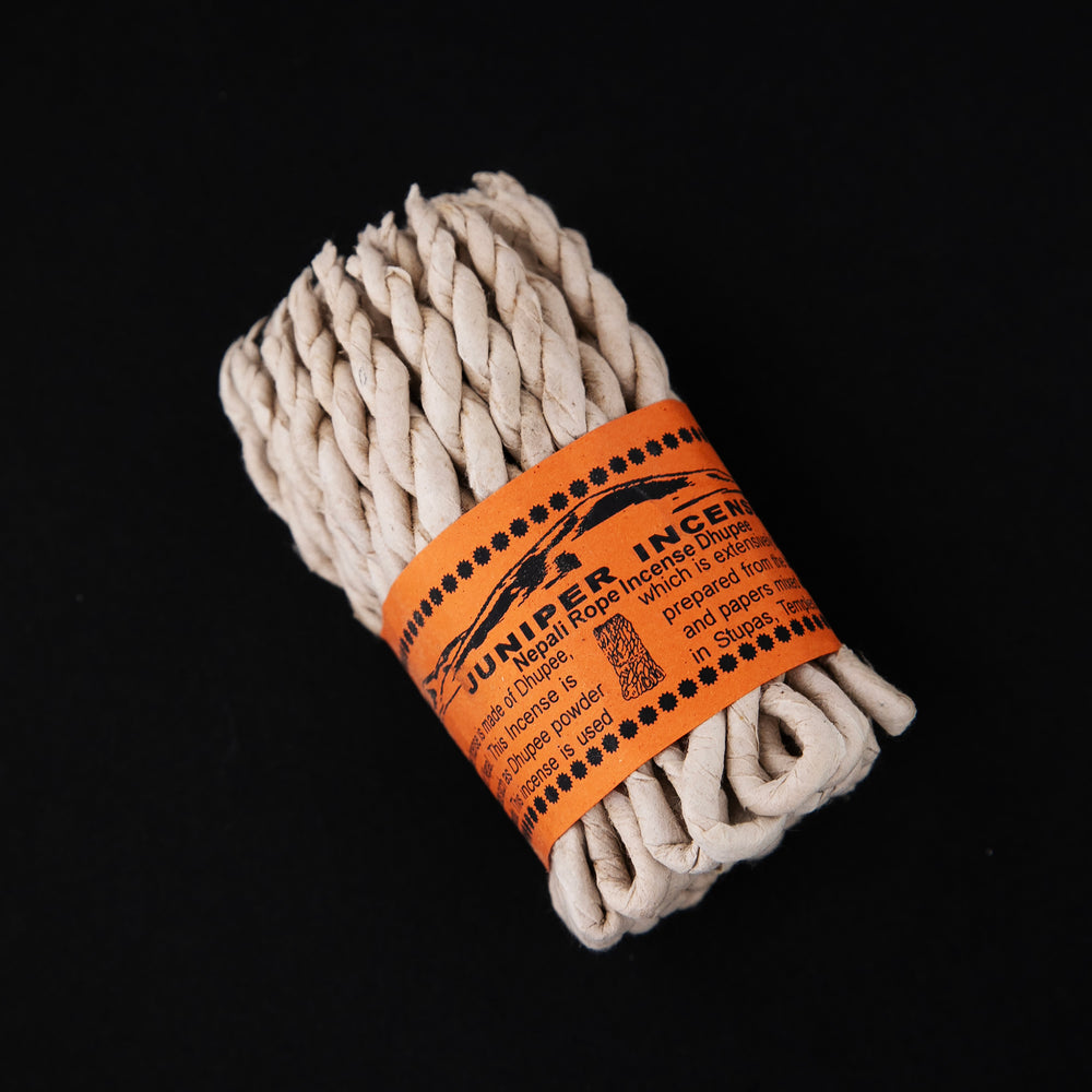 
                      
                        Bundle of juniper rope incense wrapped together with orange paper label.
                      
                    