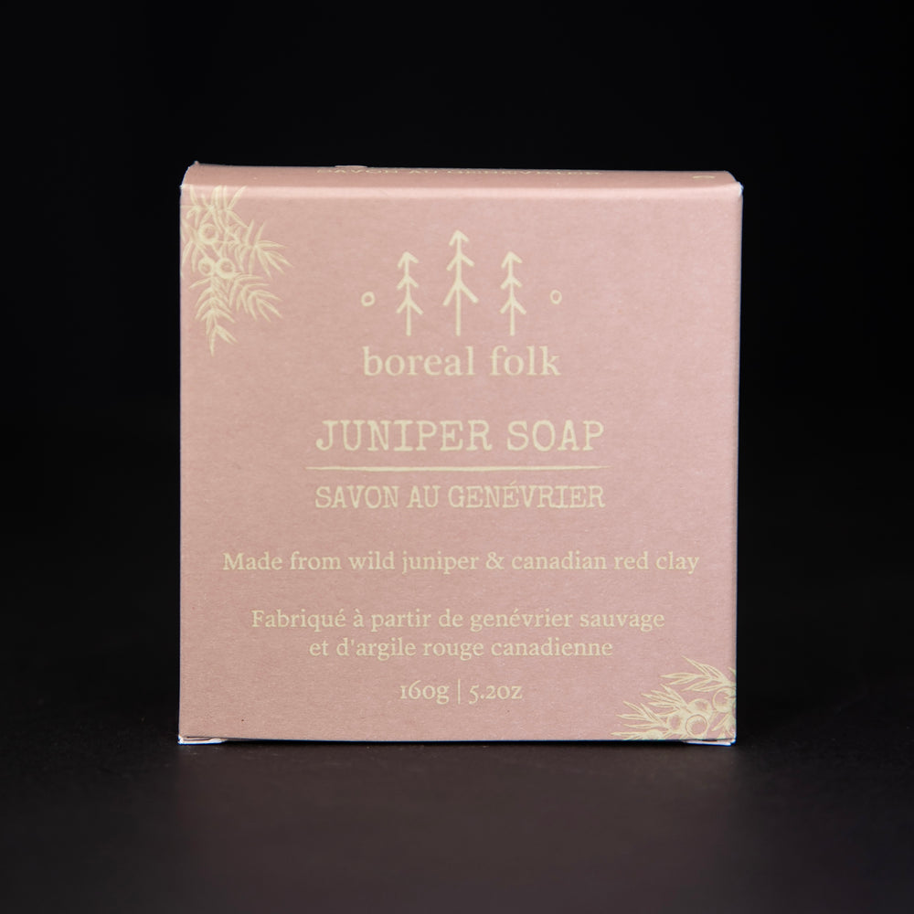 
                      
                        Earthy pink cardboard box of Boreal Folk's juniper soap against a black background
                      
                    