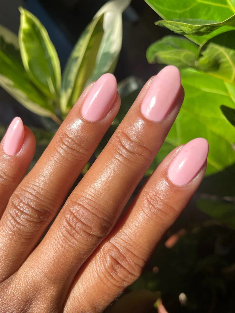 
                      
                        close up of pink polish shown on models hand
                      
                    