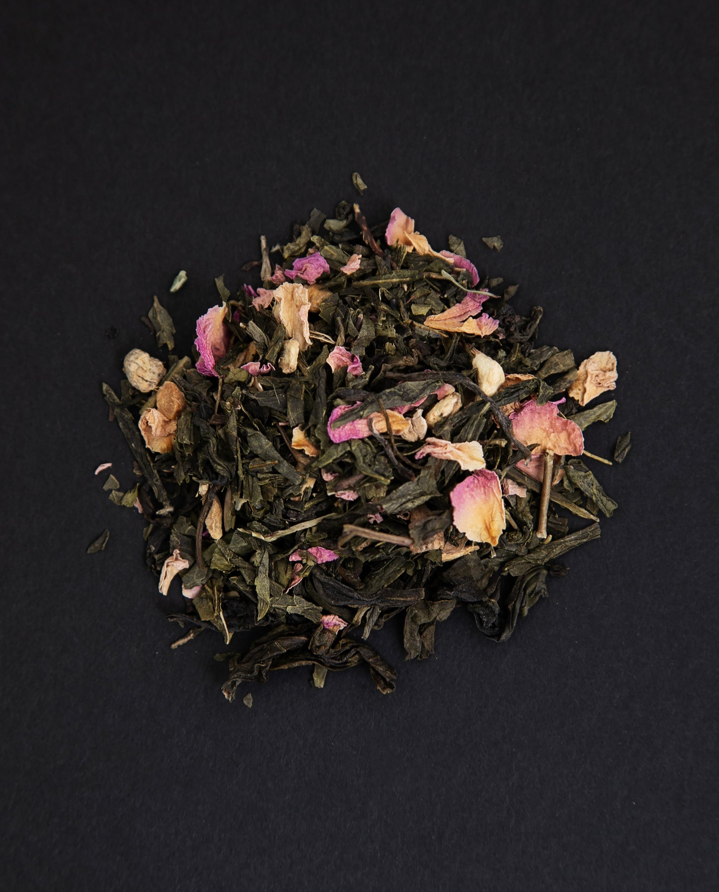 small pile of "lune rouge" tea viewed from above against a black background