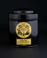 100g black laquered metal canister of Mariage Frère's "Pleine Lune" tea blend on black background.