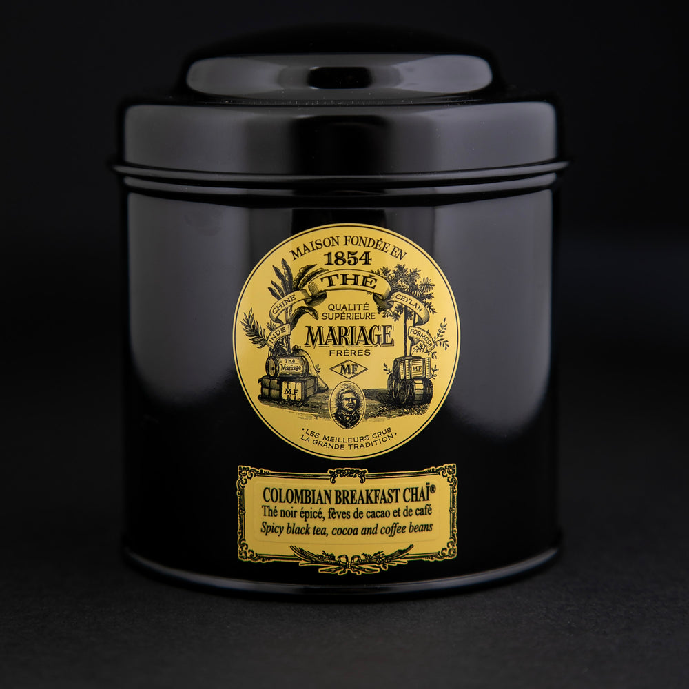 100g black laquered metal canister of Mariage Frère's "Colombian Breakfast Chai" tea blend on black background.