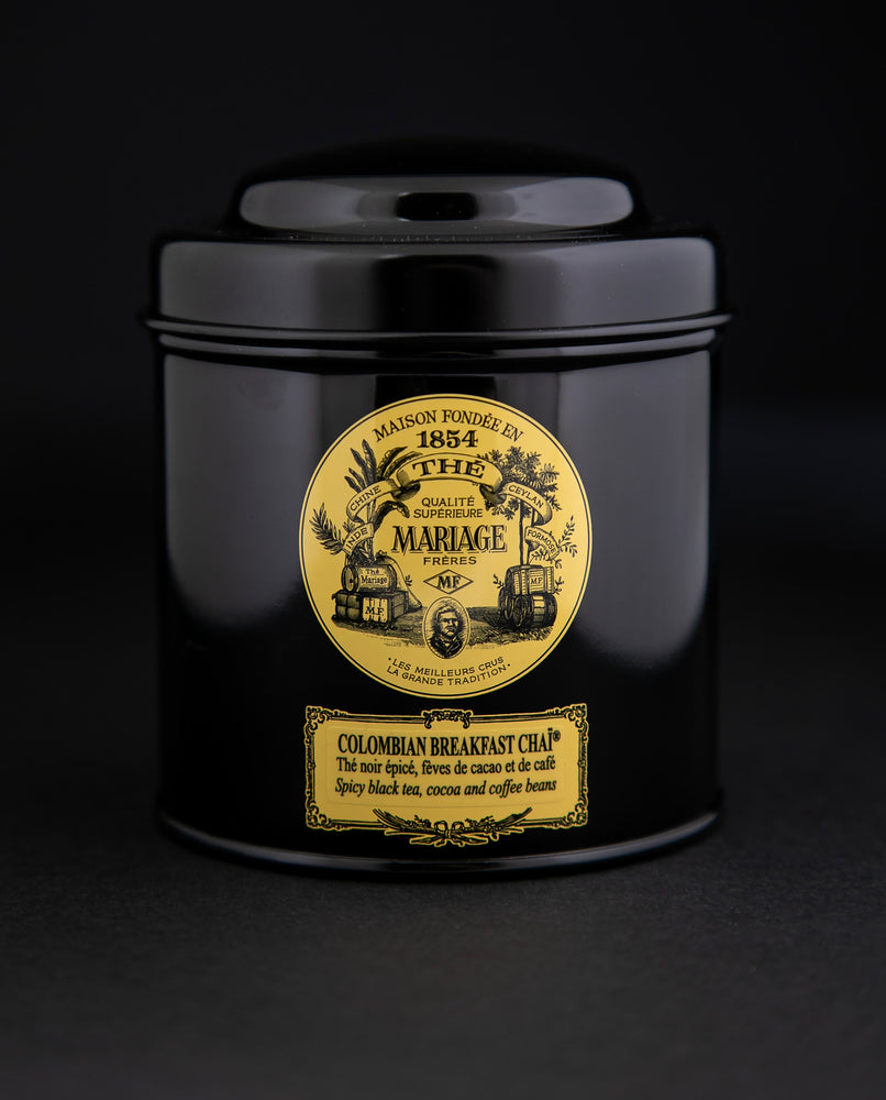 100g black laquered metal canister of Mariage Frère's "Colombian Breakfast Chai" tea blend on black background.