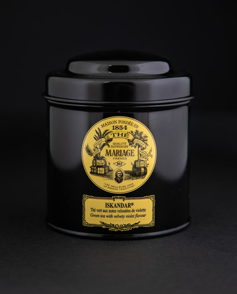 100g black laquered metal canister of Mariage Frère's "Iskandar" tea blend on black background.