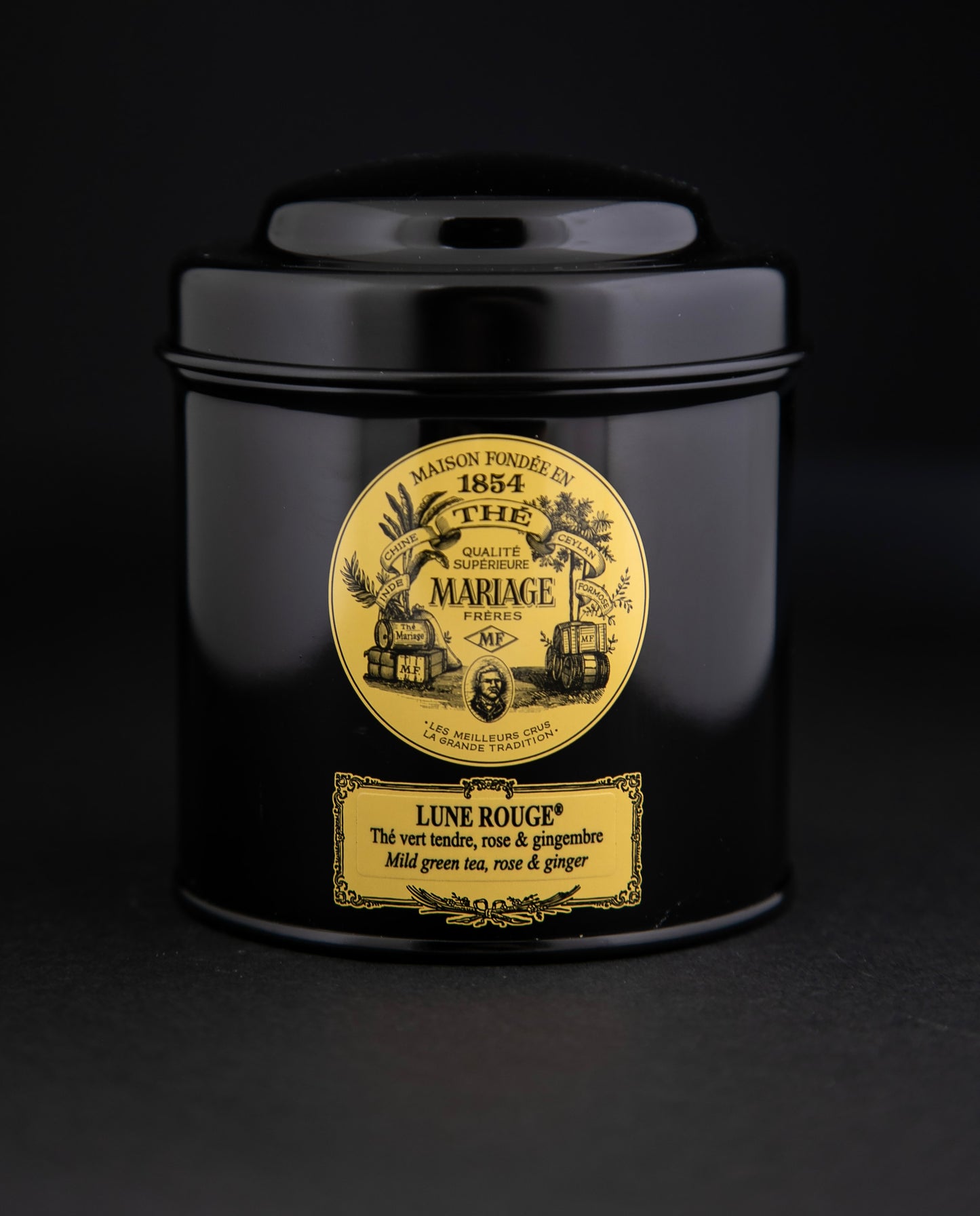 100g black laquered metal canister of Mariage Frère's "Lune Rouge" tea blend on black background.