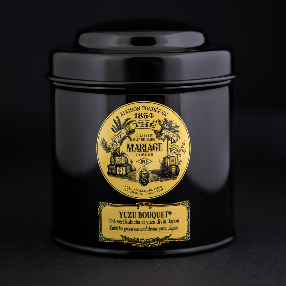 100g black laquered metal canister of Mariage Frère's "Yuzu Bouquet" tea blend on black background.