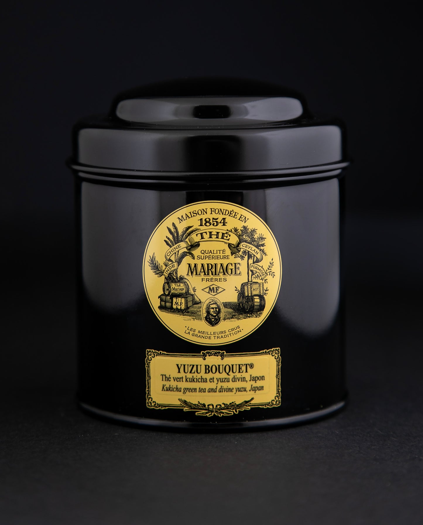 100g black laquered metal canister of Mariage Frère's "Yuzu Bouquet" tea blend on black background.