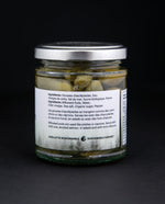 back label of a jar of milkweed pods against a black background