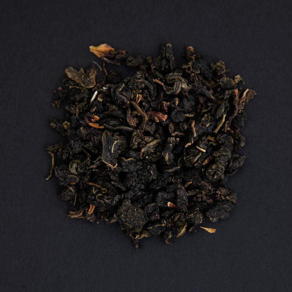 small pile of "milky blue absolut" tea viewed from above against a black background