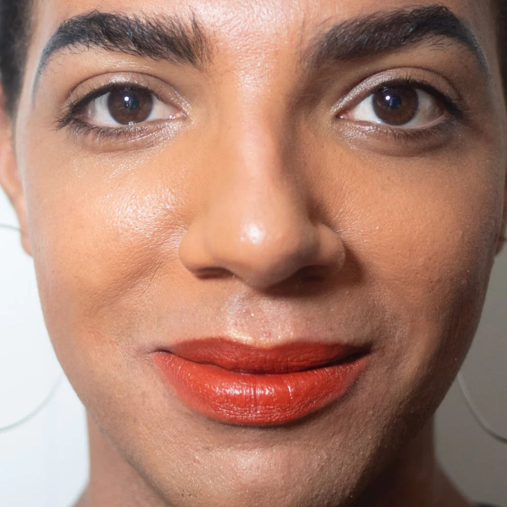 
                      
                        "Mortar and Pestle" brick red lip paint shown on model
                      
                    