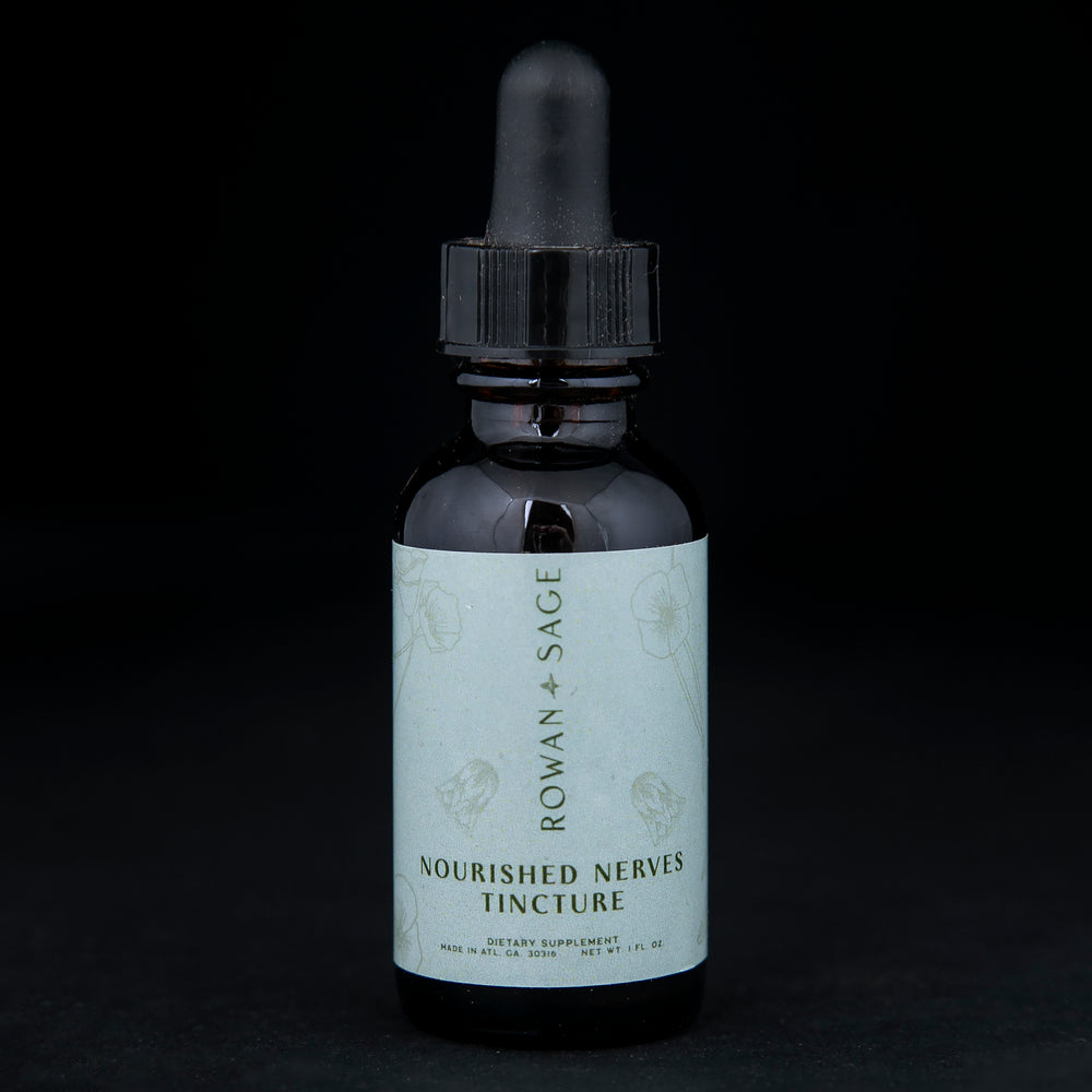 1oz amber glass bottle with dropper top and light blue label, containing Rown + Sage's "Nourished Nerves" tincture on black background.