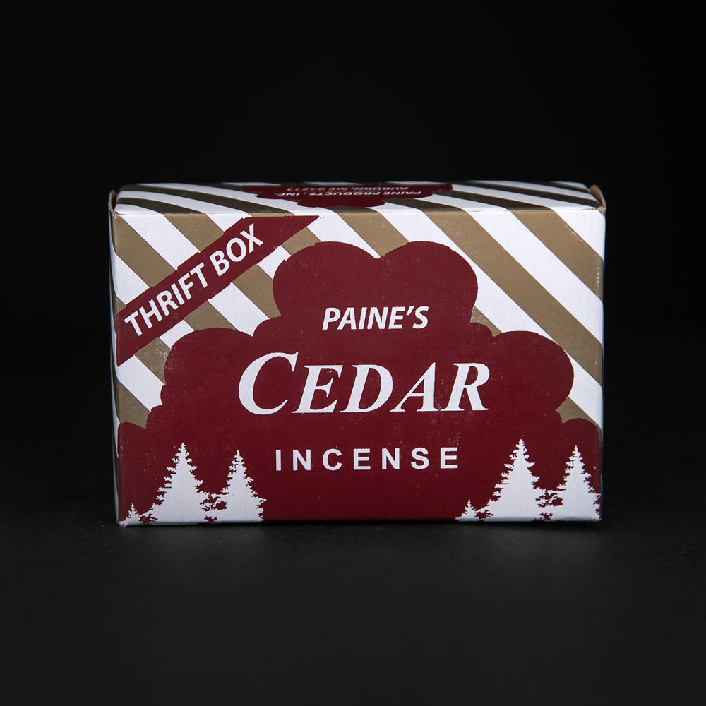 
                      
                        Closed box of Paine's Red Cedar Incense cones. The paper box is deep red, gold, and white with silhouetted illustrations of cedars
                      
                    