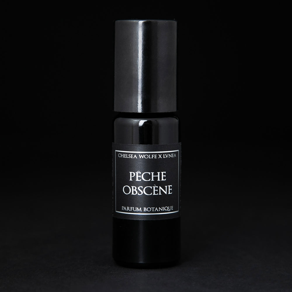 
                      
                        10ml black glass bottle of LVNEA's Pêche Obscène natural roll on perfume on black background
                      
                    