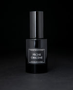 30ml black glass bottle of LVNEA's natural perfume Pêche Obscene on black background