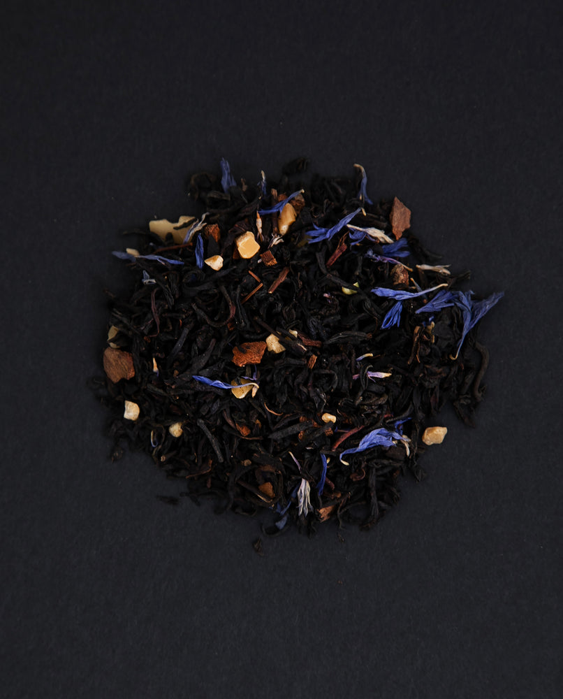 small pile of "pleine lune" tea viewed from above against a black background