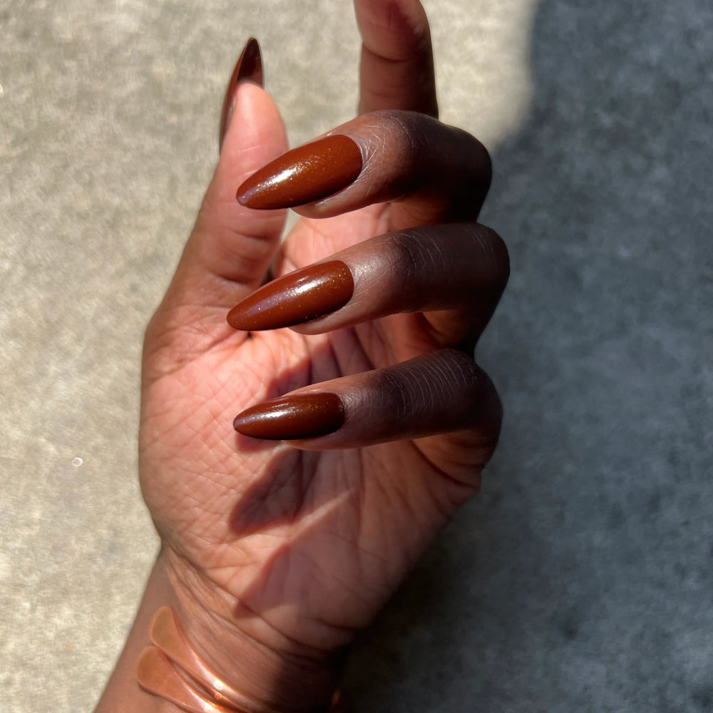 
                      
                        Close up of nails painted with Death Valley Nails "rich potting soil" nail polish
                      
                    