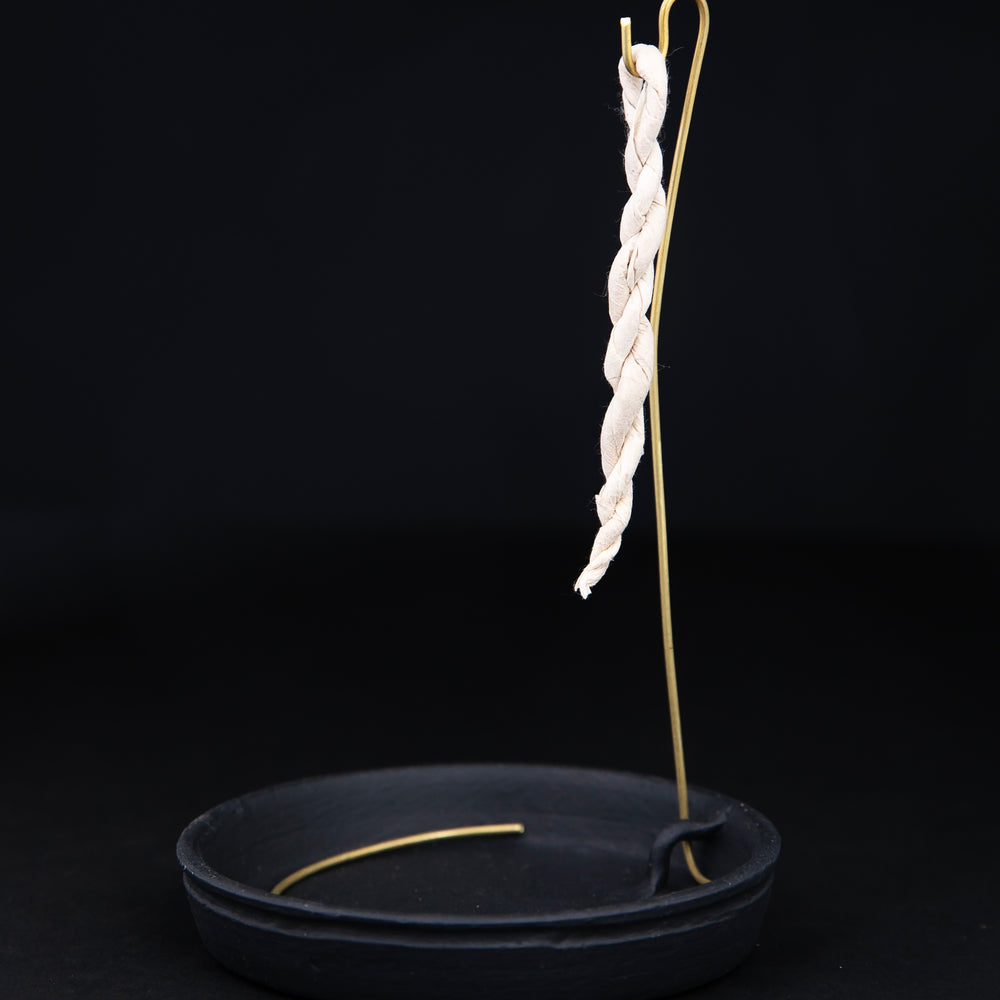 
                      
                        Rope incense holder with black ceramic base plate and brass hook on which to hang rope incense
                      
                    