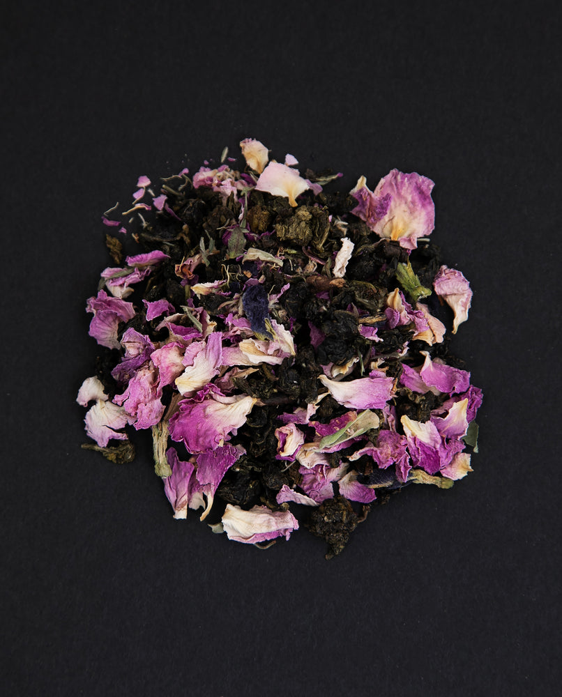 small pile of "rose d'amour" tea viewed from above against a black background