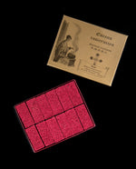 open box of rosicrucian incense, revealing 12 tightly-packed bricks of red incense