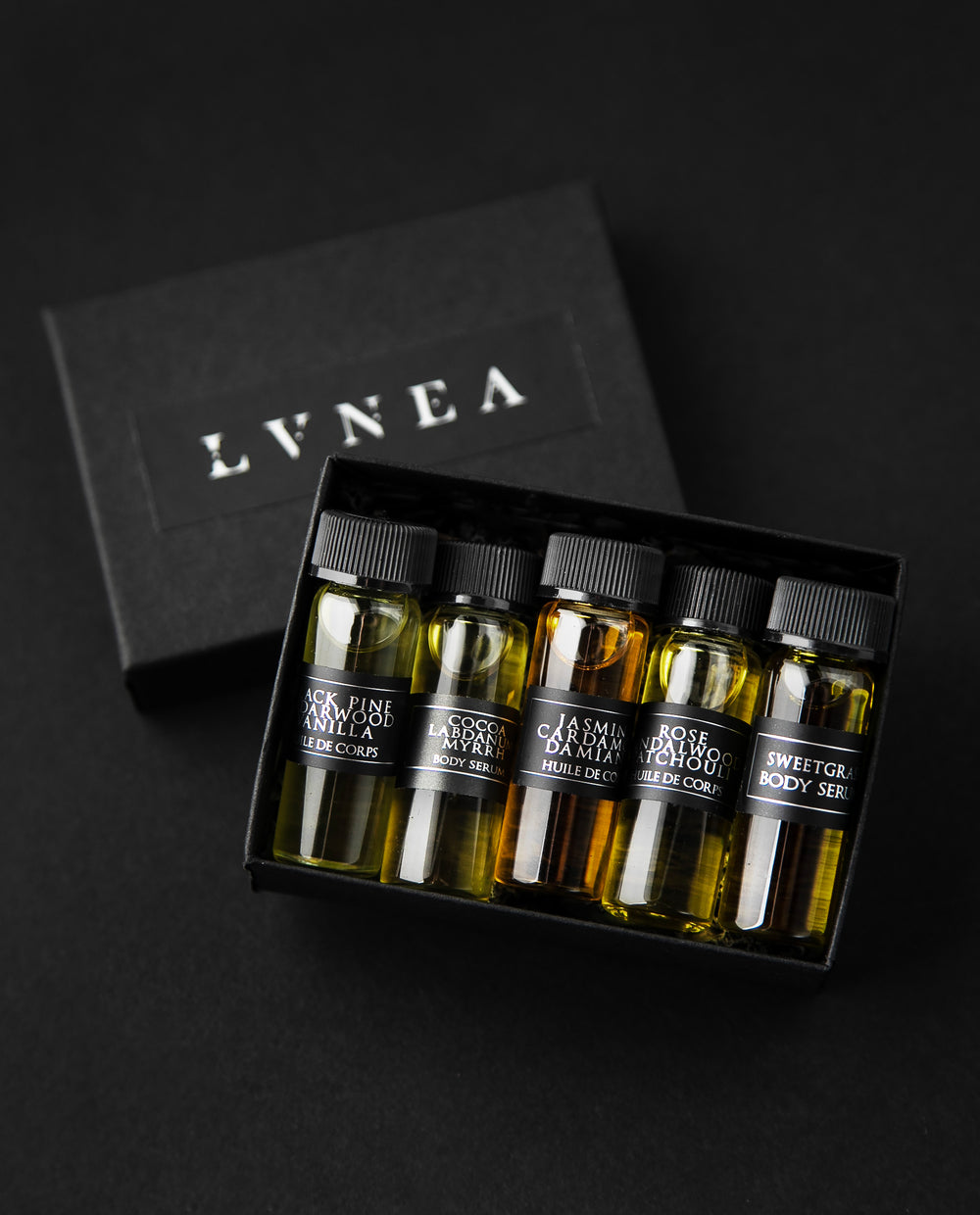 Black box filled with 4ml clear glass sample vials of each of LVNEA's five body serums.