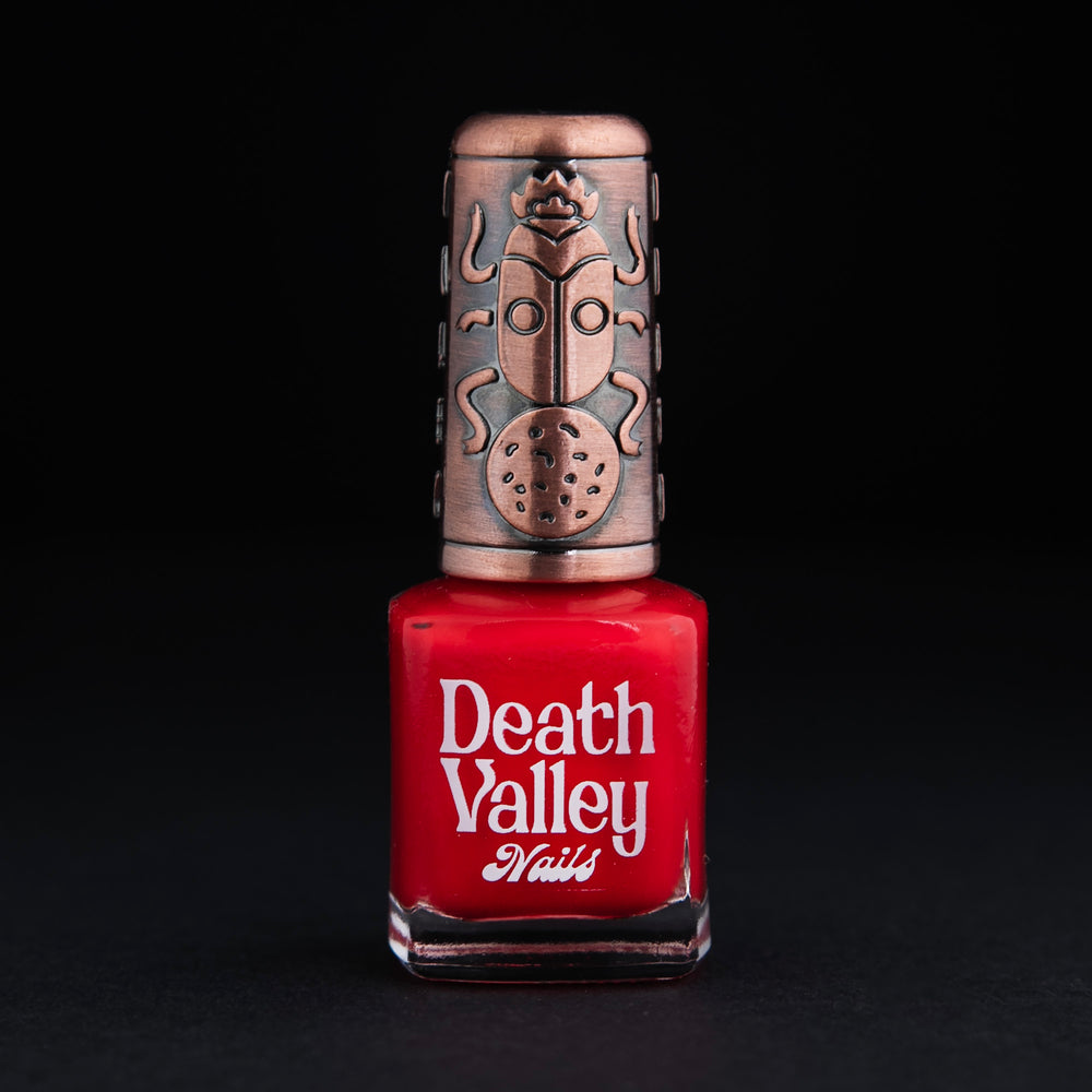 
                      
                        Bottle of "Shrimps" nailpolish on black background. The polish colour is a vibrant true red.
                      
                    