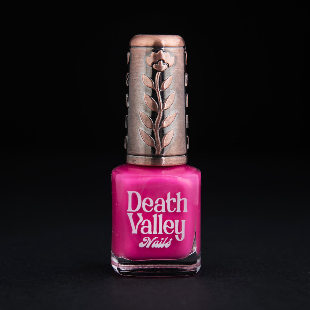 Bottle of "Sweet n Low" nailpolish on black background. The polish colour is a vibrant shimmery bubblegum pink.