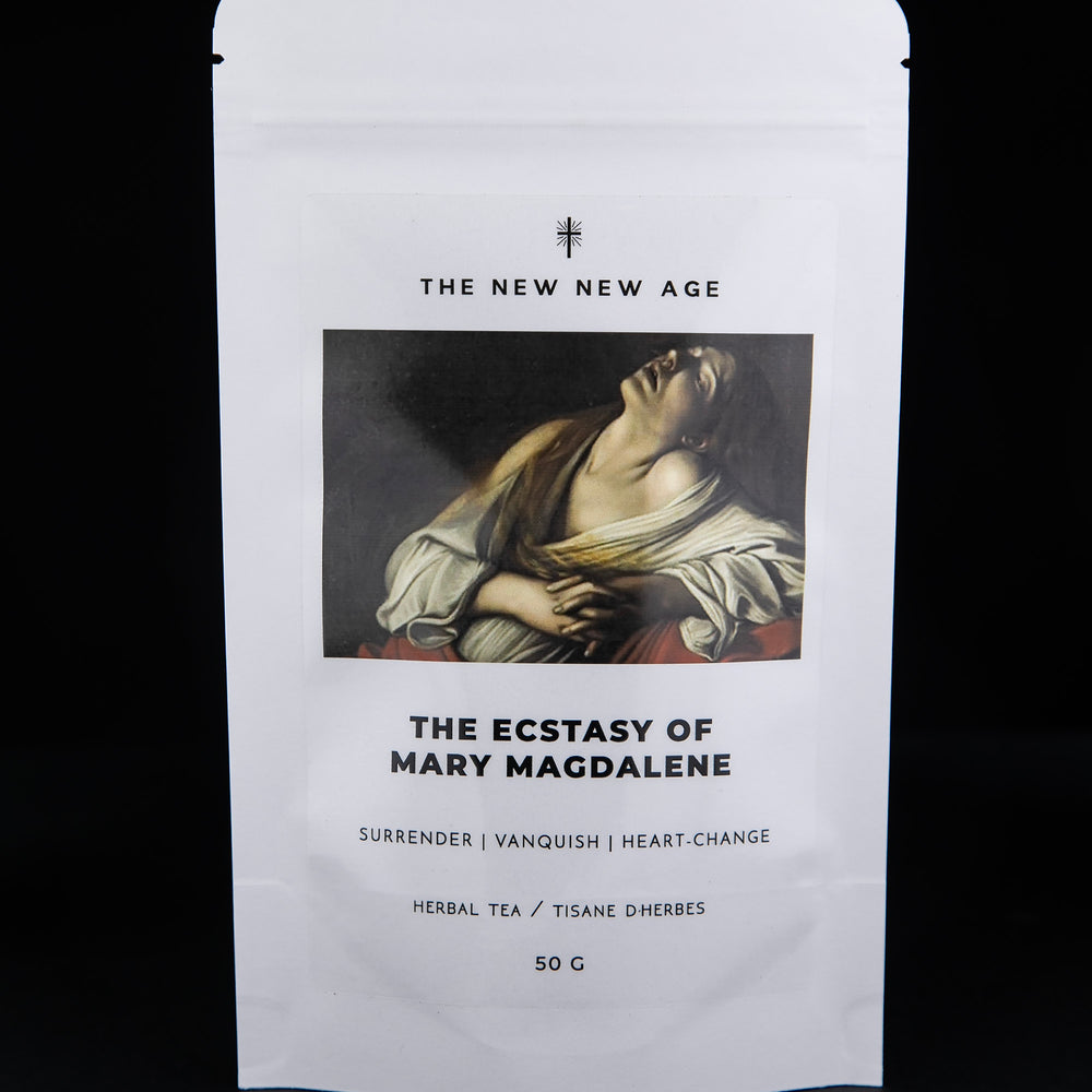 
                      
                        White 50g pouch of "The Ecstasy of Mary Magdalene" herbal tea against black background. There is an illustration of Mary Magdalene on the front.
                      
                    