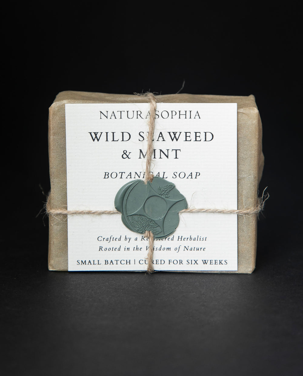 Bar of Naturasophia soap wrapped in brown paper and twine, with a label that reads 