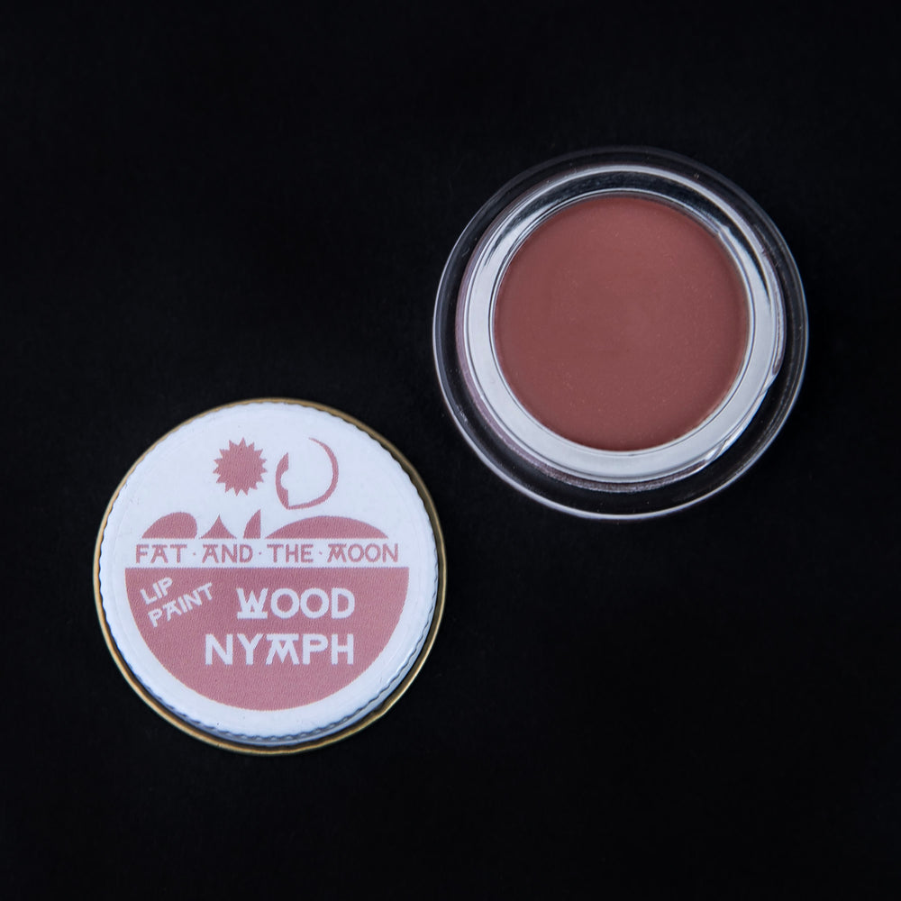 open glass pot of Fat and the Moon "Wood Nymph" lip paint, revealing a dusty rose lip colour