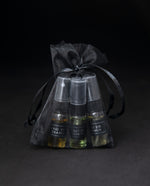 LVNEA Eau de Cologne sample set in black organza bag on black background.