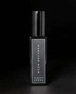 30ml black glass bottle of LVNEA's limited edition Babylon Rose perfume on black background.