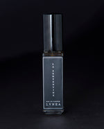 8ml clear glass bottle of LVNEA’s La Serpentine natural perfume on black background