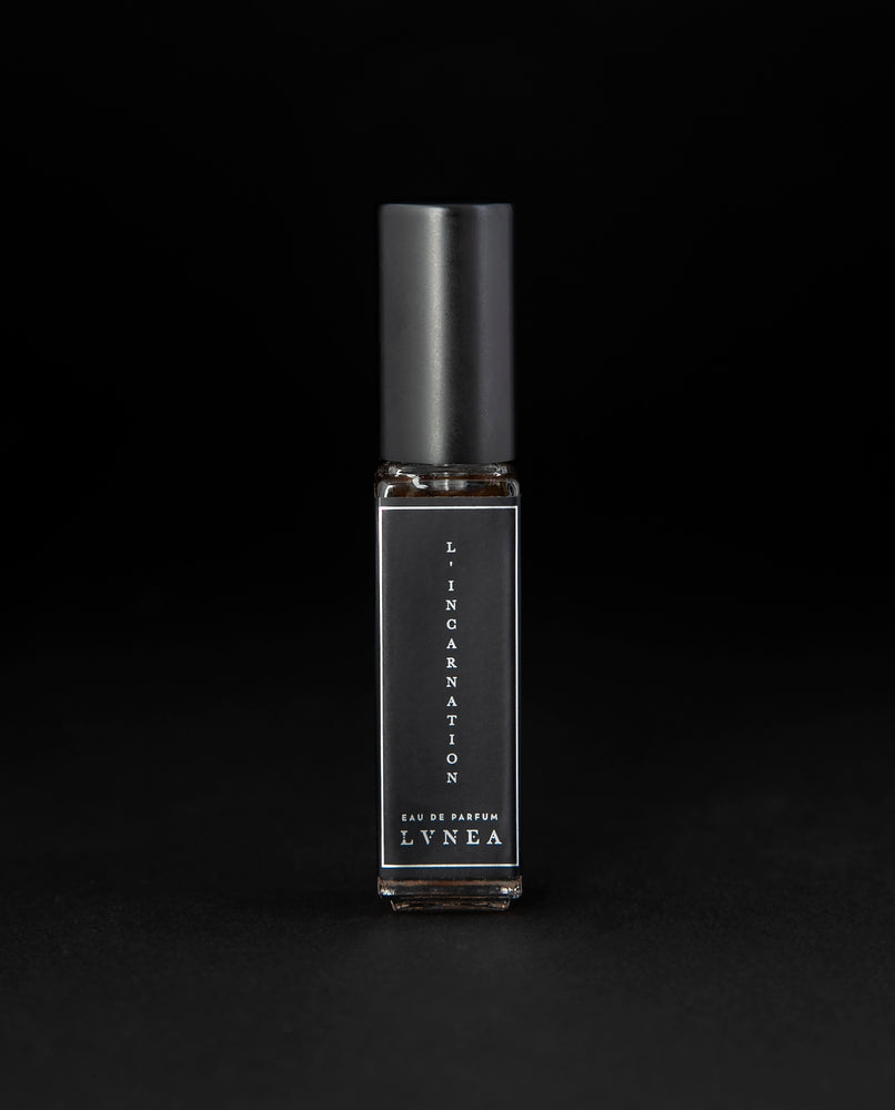 8ml clear glass bottle of LVNEA’s l'Incarnation natural perfume on black background