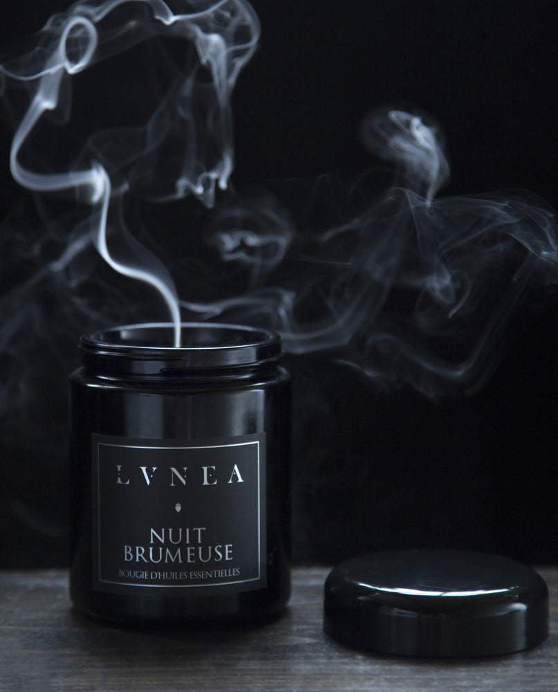 8 oz Nuit Brumeuse candle with lid removed. A plume of smoke is rising from the candle.